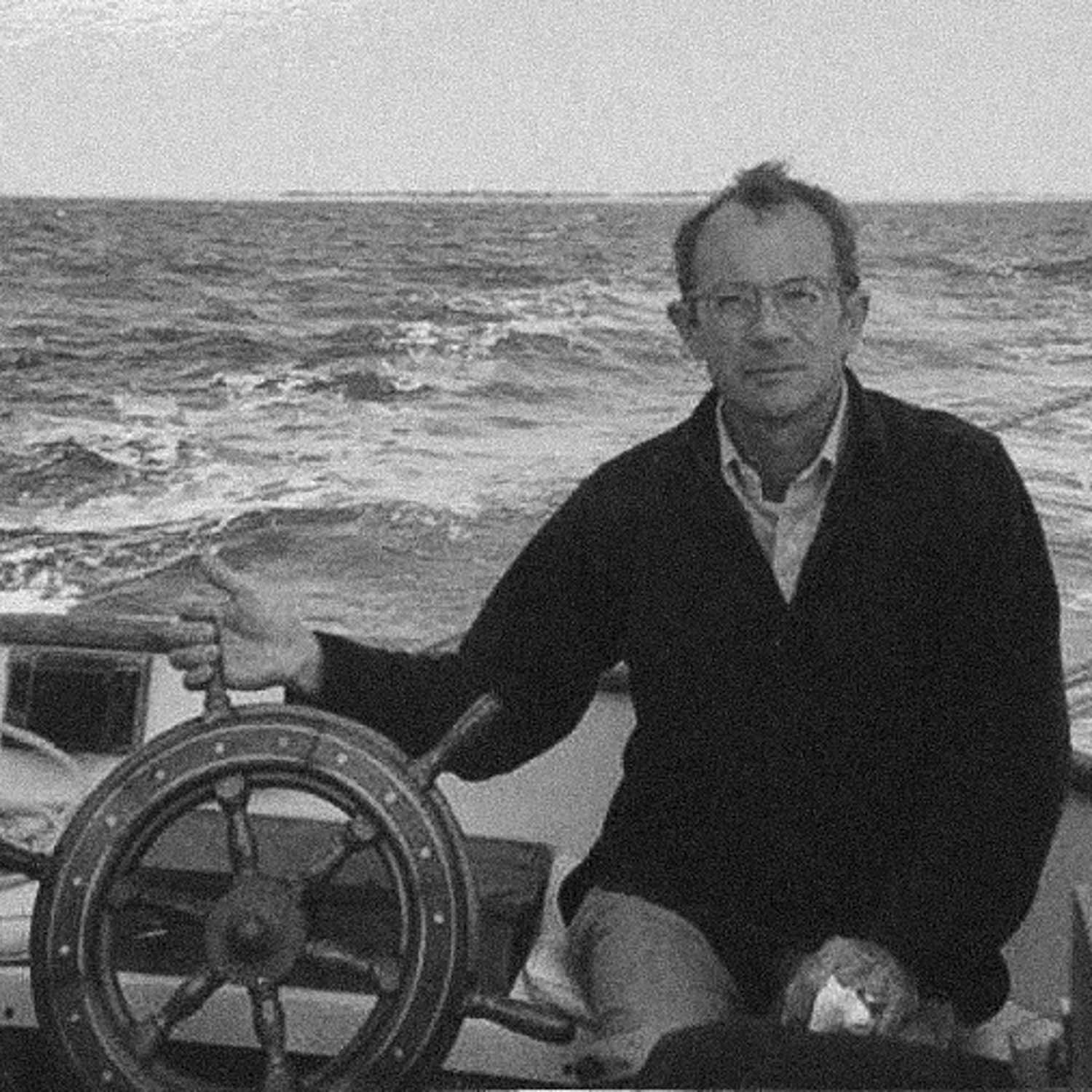 A close up of Lansing Bennet on a boat holding the helm.